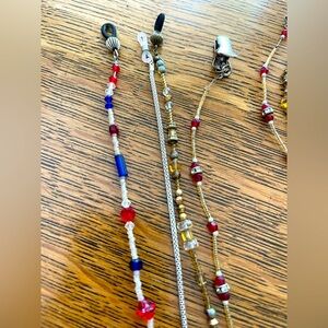 3 beaded eyeglass chains and one silver chain. Approximately 27” long. EUC
